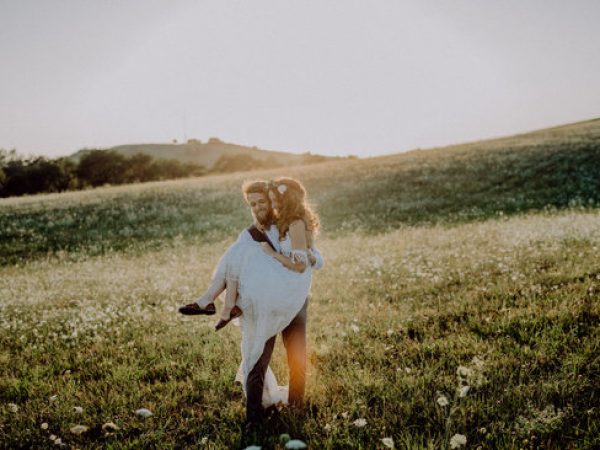 Bride and groom in field